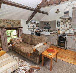 A kitchen with a sofa and dining area at Coach House Haverfordwest near Broad Haven
