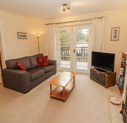 A living room with a sofa and coffee table at Flat 17 Keswick