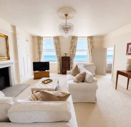 A living room with a television and a coffee table at 123 On The Sea – Victoria’s Place, Weymouth