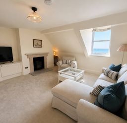 A living room with a television and sofa at 123 On The Sea – The Eaves, Weymouth