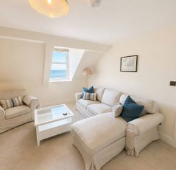 A living room with a sofa and coffee table at 123 On The Sea – The Eaves, Weymouth