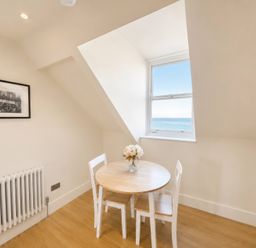A dining area with a table and chairs at 123 On The Sea – The Eaves, Weymouth