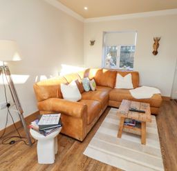 A living room with a sofa and a side table at Nene's Nest in Alnwick
