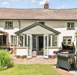 An outdoor patio with a grill at 2 Pigsfoot Cottages in Ash Thomas near Halberton, Devon