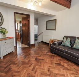 A living room with a sofa and table at Horse and Farrier Barn in Newton in Cartmel near Cartmel