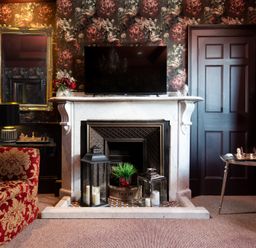 A sitting room with a fireplace and television at Wonderland in Tweedmouth, Berwick-Upon-Tweed