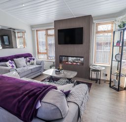 A living room with sofas and a coffee table at JacMar Lodge 14 Applethwaite, Limefitt Park near Windermere