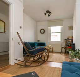 A living room with a rocking chair sofa coffee table and television at 26 High West in Weymouth
