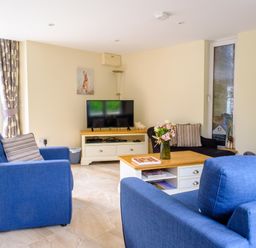 A living room with a tv and sofas at Gelli Barn near Llandeilo