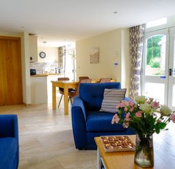 A living room with a sofa and table at Gelli Barn near Llandeilo