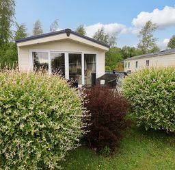 A cabin with large bushes in the outdoor area at 41, Grandma's Cottage South Lakeland Leisure Village near Carnforth