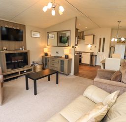 A living room with sofa and television at 41, Grandma's Cottage South Lakeland Leisure Village near Carnforth