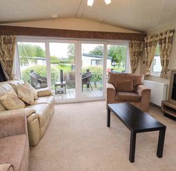 A living room with a sofa and armchair at 41, Grandma's Cottage near South Lakeland Leisure Village Carnforth
