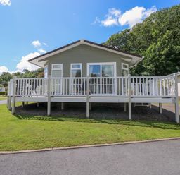 A house with a deck and steps in front at Serenity in Kilgetty