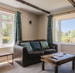 A living room with a sofa and coffee table at Woodstock in Chard