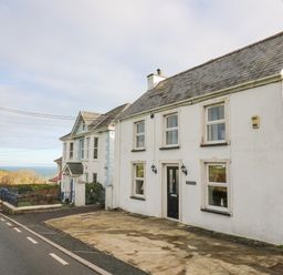 A street view with two houses and a driveway near the coast at Towyn Hall in New Quay