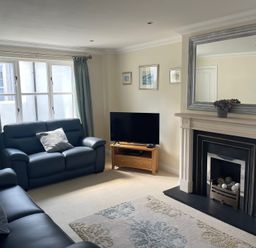 A living room with a television and sofa at 3 Strawberry Close Little Haven near Broad Haven