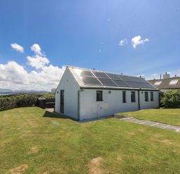 A house with solar panels and garden at Bwthyn Y Swnt Moelfre