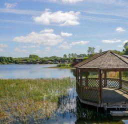 A gazebo on a lake with houses and trees in the background at Lakeside 20 in Warton near Carnforth