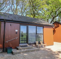A cabin with a front door and steps at Jasmine in Bydown near Barnstaple