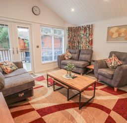 A living room with seating area and coffee table at Merewood in Troutbeck Bridge