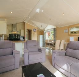 A living room with sofa and dining area at Daisy in Eardisland