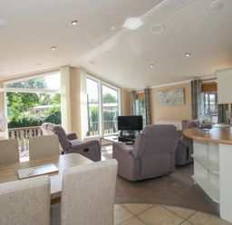 A living room with sofa and dining area at Daisy in Eardisland