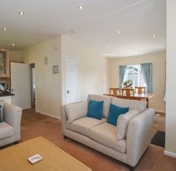 A living room with a sofa and a dining area at Daffodil in Eardisland