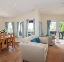 A living room with a dining area and sofa at Daffodil in Eardisland