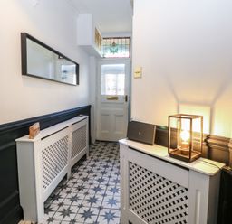 A hallway with a console table and mirror at Sunrise House in Pakefield near Lowestoft