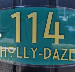 A house number sign with 114 and the name Holly-Daze at 114 Cherry Park in Chapel St Leonards