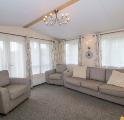 A living room with a sofa and armchair at Dove in Shobdon