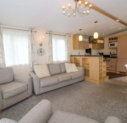 A living room with a sofa and dining area at Dove in Shobdon