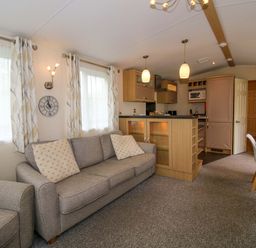 A living room with a sofa and dining area at Dove in Shobdon