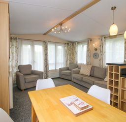 A living room with furniture and a dining area at Dove in Shobdon
