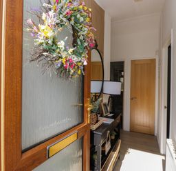 A hallway with a console table and lamp at Ruskin Lodge, Langdale 16, White Cross Bay near Windermere