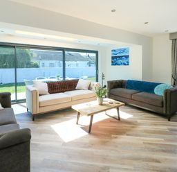 A living room with sofas and a coffee table at Iscoed in Rhosneigr