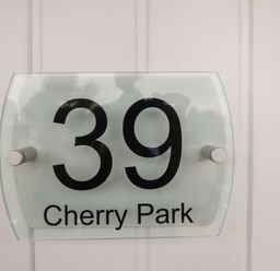 A house number sign showing 39 Cherry Park on a white door at 39 Cherry Park in Chapel St Leonards