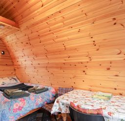A bedroom with a bed and a table at Pod 1