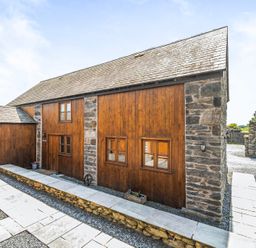 A building with wooden and stone walls at Hay Store in Corwen