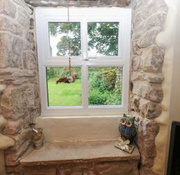 A window with stone wall and owl figurines at The LA'AL Cragg in Kirkby Stephen