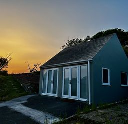 A house with large windows and a pathway at Tower Cottage Near Pembroke