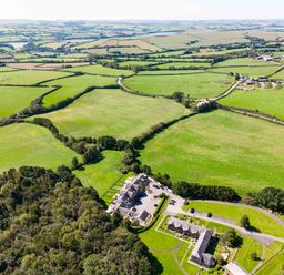 Aerial view of fields trees and buildings at Chy Pol in St Minver