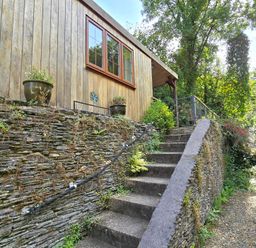 A wooden structure with steps and plants at Ty Barddu in Cwmorgan near Newcastle Emlyn