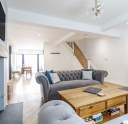 A living room with a sofa and coffee table at Neptune Cottage in Conwy