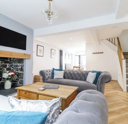 A living room with a sofa and coffee table at Neptune Cottage in Conwy