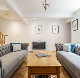 A living room with sofas and a coffee table at Neptune Cottage in Conwy