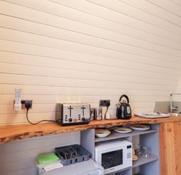 A kitchen with appliances and dishes at Pod 2 in Beauly