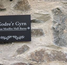 A sign reading Godre'r Gyrn at Plas Moelfre Hall Barns in Oswestry
