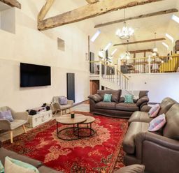 A living room with sofas and a coffee table at Godre'r Gyrn, Plas Moelfre Hall Barns in Oswestry